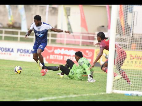 Credit: Ian Allen Photos Mount Pleasant Football Academy’s Rohan Edwards (left) beats Montego Bay United’s goalkeeper Davonnie Burton (centre) but failed to score during yesterday’s Jamaica Premier League semi-final football match at Sabina Park. The game ended 1-1.