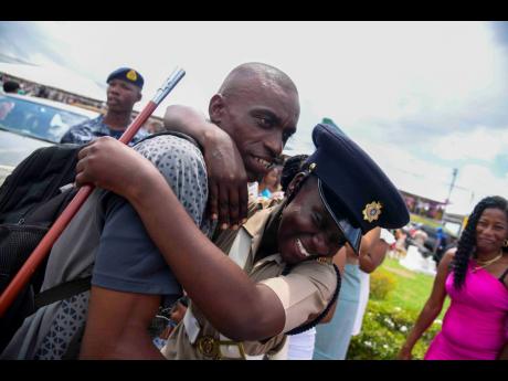 Credit: Antoine Lodge Onisha Bramwell embraces her father, Dwight Bramwell.