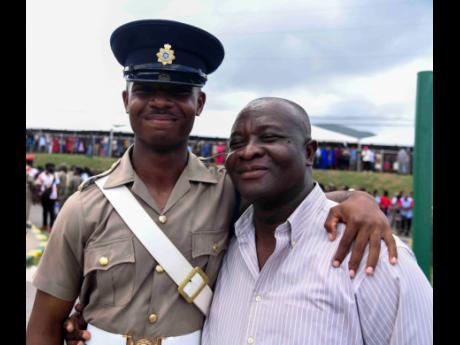Ockeem Clarke, Best Male for National Service Corps Intake 2024/0, embraces his father, Odel Clarke.
