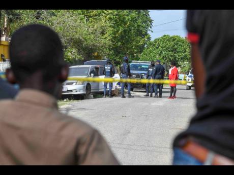 Credit: Antoine Lodge Photos Onlookers watch as the police process the scene where the body was found.