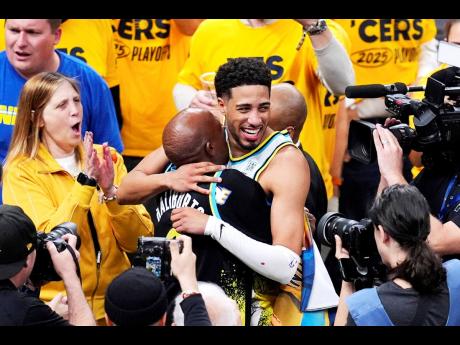 Indiana Pacers guard Tyrese Haliburton (0) hugs his father John Haliburton following Game 5 of an NBA basketball first-round playoff series against the Milwaukee Bucks on Tuesday, April 29, 2025, in Indianapolis.