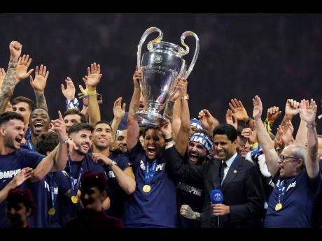 PSG’s team captain Marquinhos holds the trophy during a celebration at the Parc des Princes stadium yesterday, after the team won the Champions League soccer final 5-0 against Inter Milan in Munich, Germany on Sunday.
