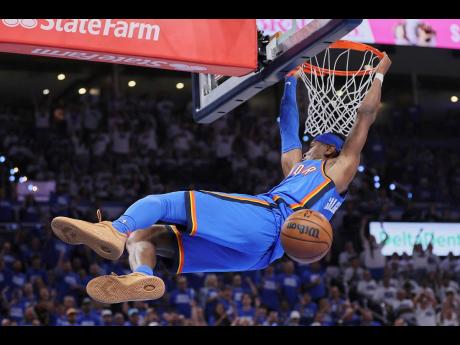 Oklahoma City Thunder guard Shai Gilgeous-Alexander (2) dunks during the second half of Game 5 of the Western Conference finals of the NBA basketball playoffs against the Minnesota Timberwolves on Wednesday, May 28.