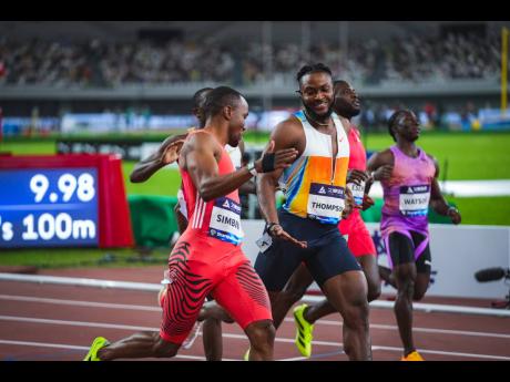 Jamaica’s Kishane Thompson (right) shakes the hand of South Africa’s Akani Simbine during the 100 metres at the Shanghai Diamond League inside the China Textile City Sports Centre last month.
