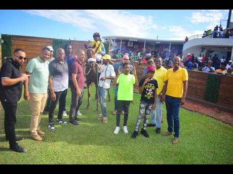Credit: Anthony Minott QUEEN OF SOUL, with Omar Walker in the saddle, is flocked by connections after winning the sixth race, running at odds of 10-1, over 5 1/2 furlongs at Caymanas Park on Saturday, May 10.