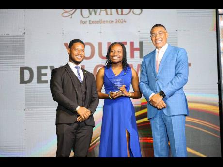 Credit: Contributed Prime Minister Dr Andrew Holness (right) poses with (from left) Percival Roberts, president of the UTech Students’ Council, and UTech student Jinel Gordon, at the recent Prime Minister’s Youth Awards.