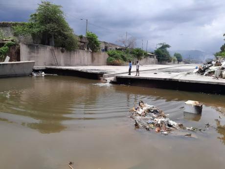 Credit: Simone Morgan-Lindo Floodwaters raged through this concrete channel of the Sandy Gully last month, sweeping away Chad Allen.