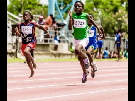 Credit: Contributed Johan-Romaldo Smythe (right) sprinting to victory at the Western Primary Schools Athletics Championship at the Montego Bay Sports Complex in 2016.