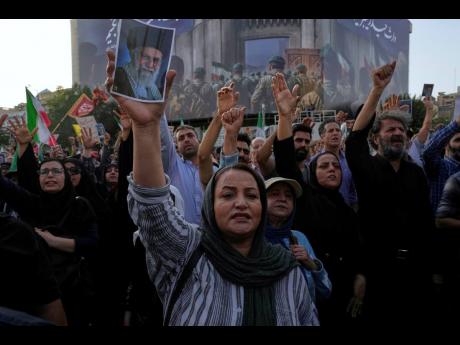 Protesters chant in a protest following the US attacks on nuclear sites in Tehran, Iran, yesterday.