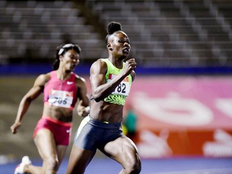 Credit: Gladstone Taylor Shericka Jackson comes off the turn ahead of Natasha Morrison during the women’s 200 metres at the 2005 JAAA National Junior and Senior Championships at the National Stadium.