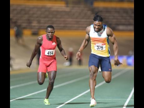 Kishane Thompson (right) wins the national men’s 100 metres title  in a personal best and world-leading 9.75 seconds at the National Stadium on Friday night. Oblique Seville (left) was second in a personal best  9.83.