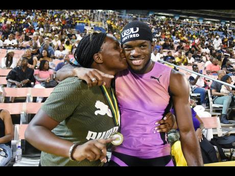 Credit: Ian Allen Orlando Bennett gets a congratulatory kiss from his sister, Abigail Bennett, after claiming the national champion title for winning the men’s 110 metres hurdles final at the Puma Jamaica Athletics Administrative Association National Junior and Senior Athletic Championships at the National Stadium yesterday.