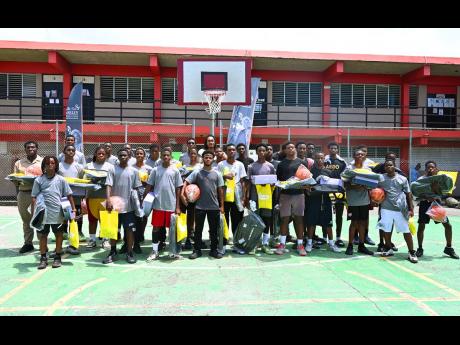 Credit: Ashley Anguin San Antonio Spurs’s Devin Vassell poses with 30 student-athletes from western Jamaica during the Devin Vassell Basketball Clinic at Herbert Morrison Technical High School in Montego Bay yesterday.