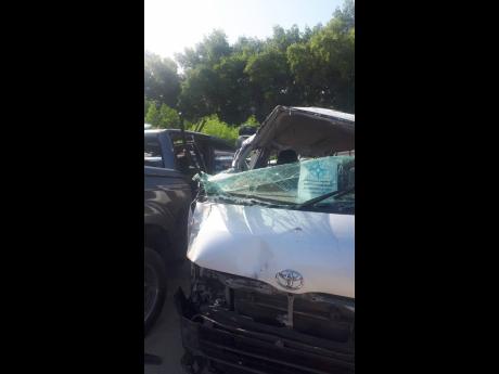 Credit: The mangled remains of the minivan that crashed along Salt Marsh main road in Trelawny on Sunday.