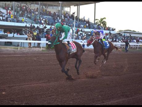 Credit: Anthony Minott/Freelance Photographer I DREAM AGAIN (left), ridden by Robert Halledeen, wins the 99th running of the Jamaica St Leger, a Grade One Stakes for three-year-olds over 10 furlongs at odds of 5-1 at Caymanas Park yesterday.