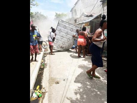 Credit: Ashanti Lawson Residents help their neighbours secure their furniture.