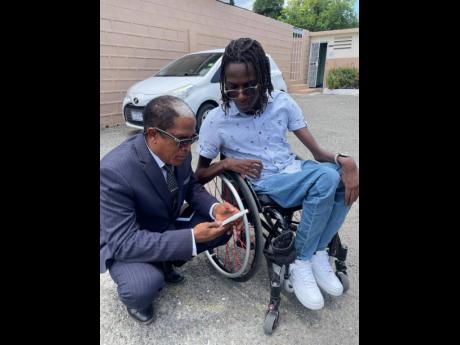 Credit: Contributed Photos Kripx (right) chats with State Minister in the Ministry of Labour and Social Security Dr Norman Dunn.