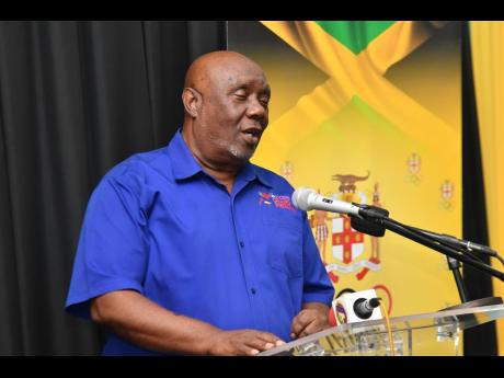 President of the Racers Track Club, Glen Mills, speaks on the club’s new partnership with the Jamaica Olympic Association at the JOA, Racers Track Club press Conference held at the JOA’s headquarters in Kingston yesterday.