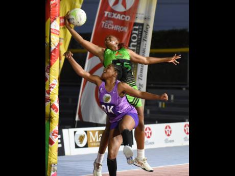 Credit: Ian Allen Dhanyel Johnson (left) of St Ann Orchids and Amanda Pinkney of Manchester Spurs battle for the ball during their Elite Netball League playoff match at the Leila Robinson Courts on Sunday.