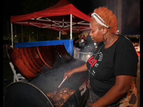 Mellisa Lawrence, jerk pan vendor, prepares her hot and ready pan chicken.