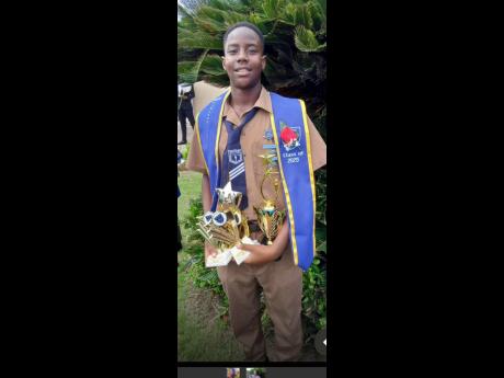 Top Student at Maverley Primary and Infant School, Caleb Newland, displays his trophies at the institution recently. Come September, he will be going to Calabar High School.
