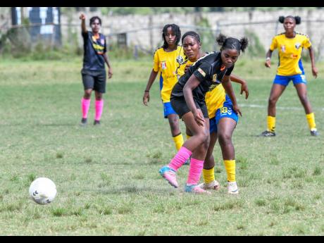 Abbygale Elliott (front) of Los Perfectos blocks Rojauna Mills (behind) of Wifi United during a Jamaica Women’s Premier League game on Saturday, March 8, 2025.
