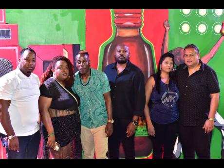 Chevanne Lawrence (left), channel and customer marketing manager at J. Wray & Nephew, and Kristoff Headley (centre), senior brand manager at AMCO, gather for a photo with winners of Magnum’s ‘Win a Trip to the Ultimate Dancehall Experience’ (from second left) Renay Bobb-Williams, Xavier Williams, Omela Dwarika and Sunil Dwarika. They were at Reggae Sumfest last Friday.