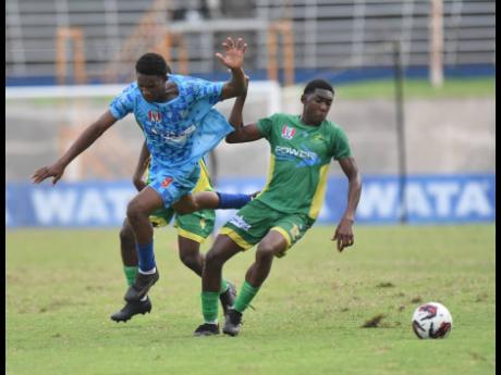 Credit: Ian Allen/Photographer Jimm Mitchell (left) of McGrath High and Ocho Rios High’s Kawayne McInnis battle for the ball during last year’s daCosta Cup semi-final at the National Stadium.