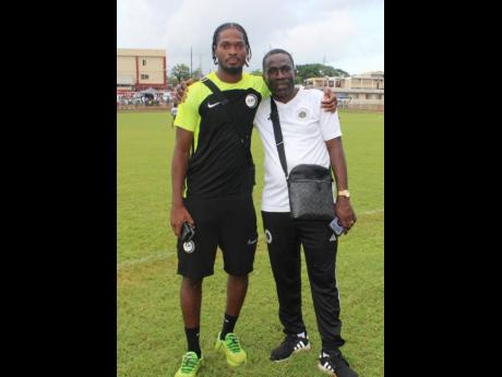 Credit: Raymond Graham Anthony Baker Jr (left), organiser of the Clarendon Elite Football competition, with his father Anthony Sr at the end of the competition on Sunday at the Glenmuir High School field.