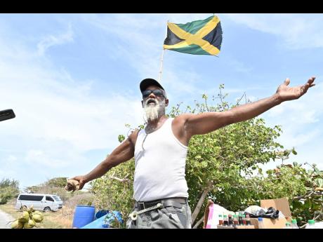 Credit: Rudolph BrownRudolph Brown Photos by Rudolph Brown/Photographer
Adrian Wilson stands proudly beside his jelly cart, the Jamaican flag waving above, ready to welcome the next set of visitors.