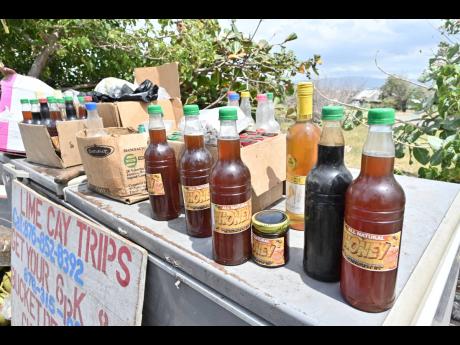 Credit: Rudolph Brown The mid-afternoon sun reflects off bottles of Adrian Wilson’s pure honey.