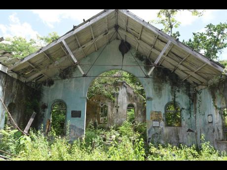The old Duppy Church, in Mile Gully, is covered in thick silence and overgrown vegetation.