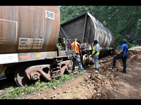 Credit: Rudolph Brown Workmen try to restore the downed train.