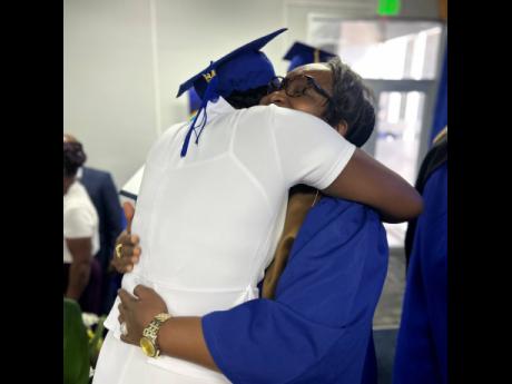A relative embraces an inmate following the graduation ceremony. 