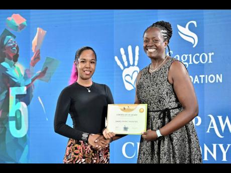 Credit: Rudolph Brown/Photographer Chorvelle Johnson Cunningham (right), CEO of Sagicor Bank, presents the certificate of award for tertiary scholarship to Isabel Thwaites at the Sagicor Foundation Scholarship Awards Ceremony at The Jamaica Pegasus hotel in New Kingston on Tuesday.
