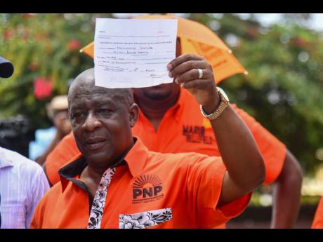 Credit: Matthew McKoy PNP candidate for Central Manchester Donovan Mitchell shows off his nomination receipt.