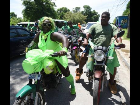Bikers motor along in Black River, during Nomination Day activities.