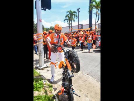 This PNP supporter shows off his skills in Mandeville, Manchester.
