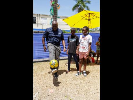 Credit: Contributed Kevin Ingram, head of branch sales at NCB, showed his football skills to young men in the Kids’ Zone at NCB’s ‘Sum’n Nice fi Dem Future’ Back-to-School Fair at its St Ann’s Bay branch. The day featured games, giveaways, and free health checks, helping families get ready for the new school year.
