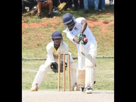 Credit: Ian Allen Pajay Nelson (right) of Manchester High in action against May Day High during last year’s Headley Cup final. Looking on is wicketkeeper Javed Williams of May Day.
