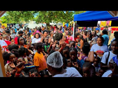 Credit: Contributed Residents of Payne Land, St Andrew at the back-to-school fair hosted by Janice Francis, native of the community and founder of the Teen Moms Initiative.