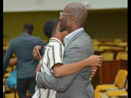 Credit: Antoine Lodge Young scholar Daniel* gets a hug from his dad at the recent Child Protection and Family Service Agency’s PEP Awards Ceremony, held at the Jamaica Conference Centre in downtown Kingston.