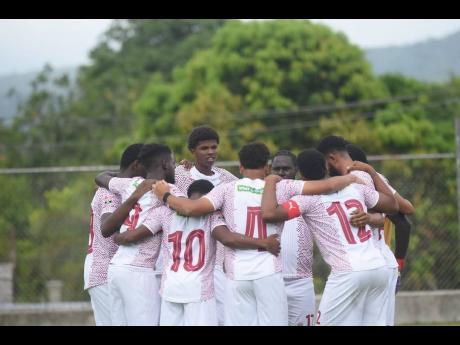 Chapelton Maroons players huddle ahead of the start of their first Jamaica Premier League game against Tivoli Gardens at Turner Park on Sunday.
