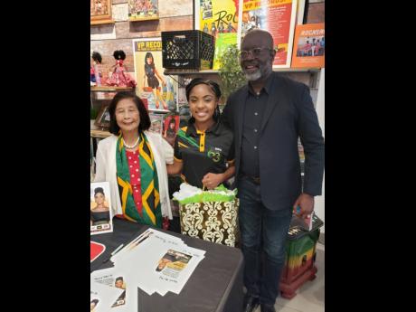 From left Patricia Chin, CEO, VP Records; Abigail Dunstan JCDC Festival Song Competition winner; and Clive Blackwood, executive vice president for the Federal Reserve Bank of New York at VP Records headquarters in New York.