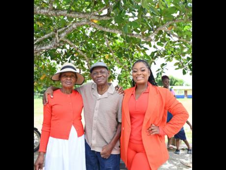 People's National Party candidate for St James Southern, Nekeisha Burchell (right) shares lens with her mother Veronica Burchell and father Pastor Egbert Burchell at the Garlands Primary in St. James Southern constituency earlier today..