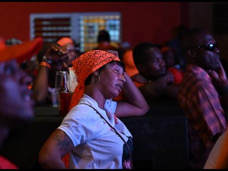 A dejected People’s National Party supporter reacts in disbelief as it became clear that the party had lost last Wednesday’s general election.