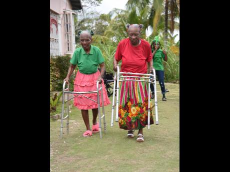 Elsada Dunn (left) and Elsi Gordon (right) use walkers as they race each other during the Sports Day for the Elderly at SP Home Away from Home in Guy’s Hill, St Mary, in August.
