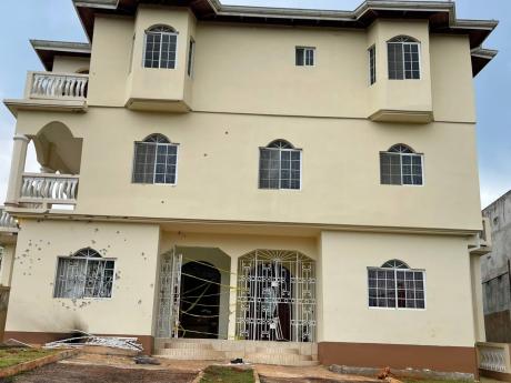 Credit: Simone Morgan-Lindo The building in which Dave Alfrancis Wilson engaged police in a four-hour stand-off on Tuesday in Mandeville, Manchester.