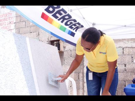 Credit: Contributed Asheaka James, trade marketing manager at BPJL, adds finishing touches to the Trowel-On demo at Wilson Chung & Sons Building Supplies Ltd, St Thomas.