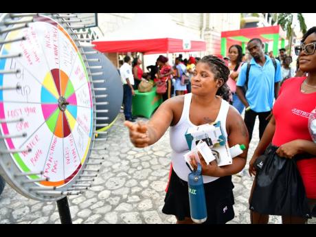 Credit: Contributed A patron spins the wheel during the Ballin with JustBet Roadshow in Sam Sharpe Square, Montego Bay, St James.